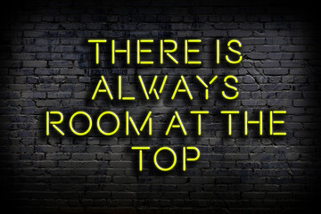 wise quote. neon inscription against brick wall