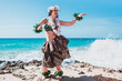 Hawaiian woman enjoys hula dancing on the beach barefoot wearing traditional costume. Hawaii dancer. Lady dancing to the rhythm with the waves of the sea. Woman and flowers hawai concept