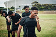 © Allistair/peopleimages.com - Its half-time. Cropped shot of a handsome young rugby player removing his mouthguard during half-time on the field.