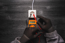 No Mains Voltage In The Electric Plug  Concept. Electric Voltmeter With Zero On The Display And Hands Of Electrician.