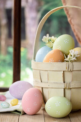 Wall Mural - Colored easter eggs and basket by a window