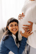 © (JLco) Julia Amaral - Young lesbian woman listening to her unborn baby kicking