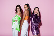 © LIGHTFIELD STUDIOS - cheerful multiethnic women in trendy outfits posing on pink