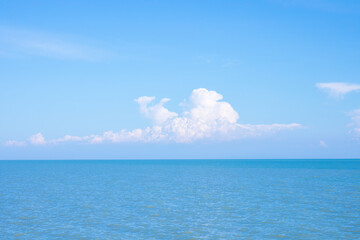 Wall Mural - sea or ocean calm water with blue sky and white clouds.