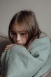 © Forewer - Stop war. Pray for Ukraine. we stand with Ukraine. Ukrainian frightened child under a blanket. The girl is afraid of the sounds of air raids and explosions. Poor child feeling sorrow and sadness.