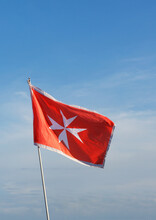 Close-up Of A Maltese Flag Against A Blue Sky, Malta