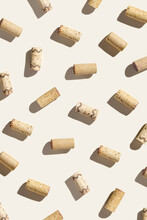 Creative Pattern With Wine Corks On Beige Background With Hard Light And Shadows At Sunlight. Minimal Style Layout With Bottle Cap From Red And White Wine,  Wine List Backdrop
