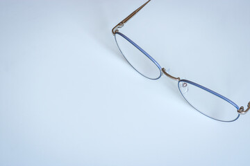 Glasses in an elegant thin frame on a light background.