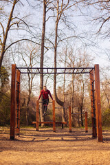 Wall Mural - Man exercising in street workout park