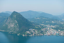 Panoramic View Over City Of Lugano And Mountain Peak With Alpine Lake In Ticino, Switzerland.