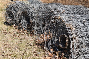 Rolls of wire fencing in a field