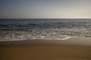 A pleasant and relaxing beach. Copy space on the orange sand or in the blue sky.