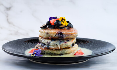 Wall Mural - stack of pancakes with condensed milk and fresh berries