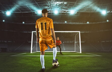 Soccer Scene At Night Match With Player In Yellow Uniform Kicking The Penalty Kick