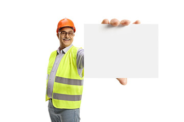 Wall Mural - Cheerful male engineer in a reflective vest showing a blank card