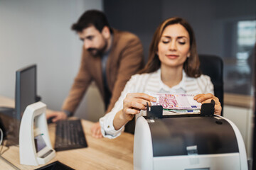 Wall Mural - A man and a woman work together in an exchange office.