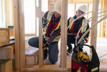 Female Engineers Inspecting House Under Construction