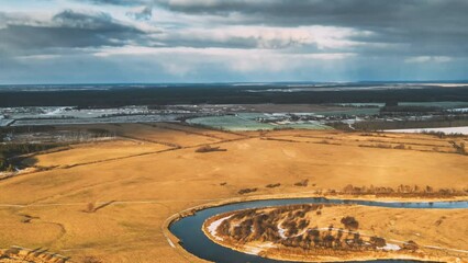 Wall Mural - Aerial View Of Dry Meadow And Partly Frozen River Landscape In Sunny Autunn Day. Top View Of Beautiful European Nature From High Attitude In Autumn Season. Drone View. Bird's Eye View. Hyperlapse. Set