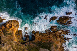 Fototapeta Paryż - Aerial photo of the rugged coastline of Knysna, Western Cape, South Africa.  Photo taken using a drone over the cliffs, beaches and coastline.