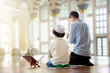 © famveldman - Ramadan Kareem greeting. Father and son in mosque.
