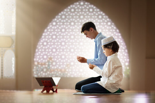 Ramadan Kareem greeting. Father and son in mosque.