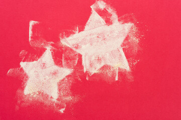 two dusty pastel chalk stars on red paper