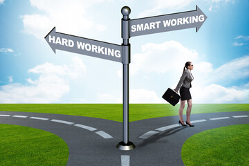 Businesswoman at the crossroads on working smart or hard