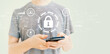 © Tierney - Internet network security concept with young man using a smartphone