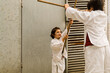 © Xan Gasalla - two children play karate in the street