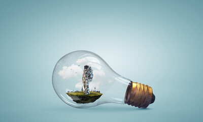 Wall Mural - spaceman inside light bulb . mixed media
