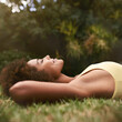 © Mapodile M./peopleimages.com - Relaxing on a golden afternoon.... Shot of a relaxed young woman lying on the grass with her eyes closed.