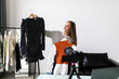 © F8  \ Suport Ukraine - Pretty young woman selling clothes and accessories online live streaming, business online e-commerce at home