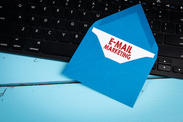 Wall Mural - e-mail marketing concept. blue letter envelope on black computer keyboard