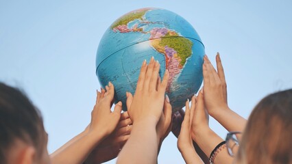 friends spin the globe high above them.