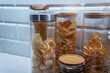 Pipe rigate and other varieties of pasta in a glass jars