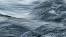 Rapid Water Flow In Mountain Stream With Silky Surface And Motion Blur - Abstract Landscape Close Up