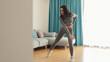 © shevtsovy - Athletic woman sports workout at home, squats. Home workout. Slim female stretching at home and weight loss workout in a living room.