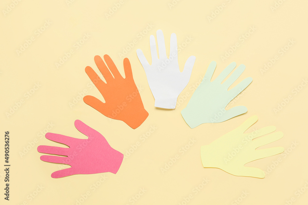 Paper human palms on beige background. Concept of autistic disorder