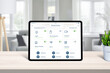 © Stanisic Vladimir - Tablet with smart home app on home desk. Concept of home automatization conrol app with frequently used devices