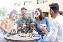 Happy Multiracial Friends Group Drinking Beer At Brewery Pub Restaurant - Friendship Concept With Young People Having Fun And Laughing Together - Focus On Asian Man