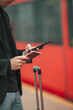 © travnikovstudio - Young caucasian man with smarphone and luggage at station traveling by train