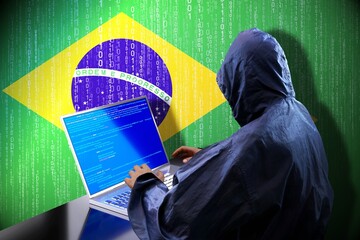 Anonymous hooded hacker, flag of Brazil, binary code - cyber attack concept