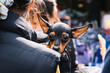 Miniature Pinscher is looking at the camera. Woman huging the puppy on the street. A miniature version of the German pinscher.