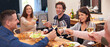 © Marius V/peopleimages.com - Heres to family. Cropped shot of a family sharing a meal around the dinner table.