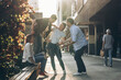 © BalanceFormCreative - Young friends hang out on the city street.They go for walks together and have fun in the city downtown.