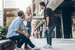 © BalanceFormCreative - Young friends hang out on the city street.They go for walks together and have fun in the city downtown.