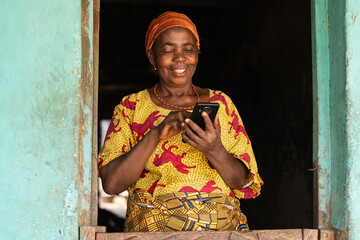 smiling elderly african woman using her phone