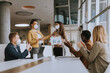 © BGStock72 - Group of multiethnic business people working together with facial protective masks and preparing new project on a meeting in office