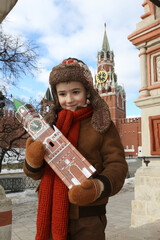 Wall Mural - Russian tourist child on Red Square. Spasskaya Tower, Kremlin in Moscow city, Russia. Spasskaya Tower, Kremlin in Russia. Moscow landmark, Russian monument. Moscow Kremlin. New Year, winter in Russia