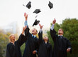 © Nicola Katie/peopleimages.com - Heres to the rest of our lives. A group of students throwing their caps into the air after graduation.